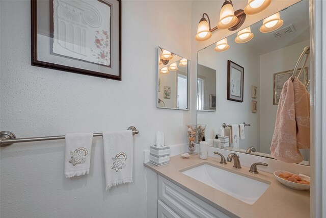 bathroom featuring vanity and visible vents