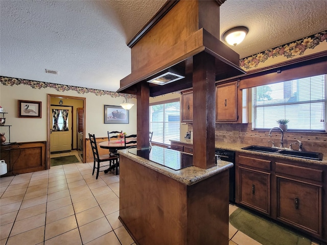 14926 Carols Way Dr, Houston, TX 77070 - kitchen with light tile patterned floors, a textured ceiling, a sink, and a kitchen island
