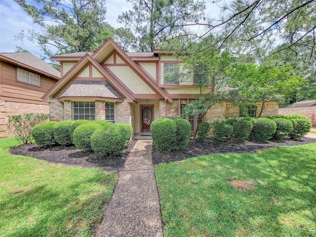 14926 Carols Way Dr, Houston, TX 77070 - tudor-style house featuring stucco siding, brick siding, and a front lawn