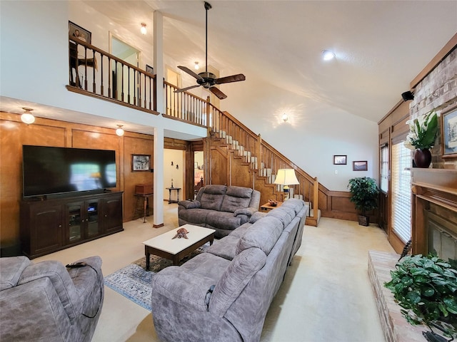 14926 Carols Way Dr, Houston, TX 77070 - living area with stairway, ceiling fan, high vaulted ceiling, a glass covered fireplace, and light colored carpet