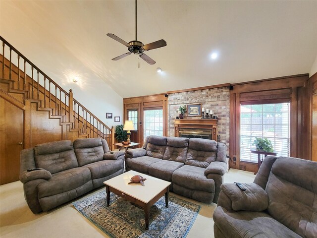 14926 Carols Way Dr, Houston, TX 77070 - living room featuring stairs, ceiling fan, a brick fireplace, high vaulted ceiling, and wooden walls
