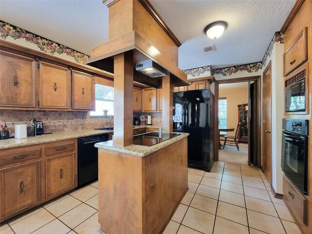14926 Carols Way Dr, Houston, TX 77070 - kitchen featuring visible vents, black appliances, a textured ceiling, and brown cabinets