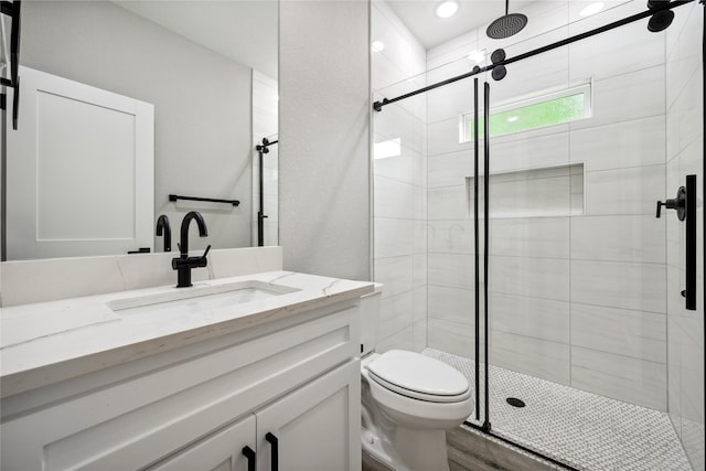 full bath with toilet, a shower stall, and vanity