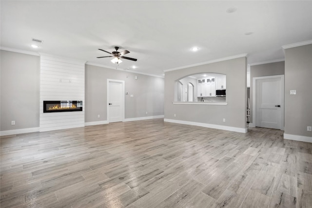 unfurnished living room with recessed lighting, light wood-style floors, ceiling fan, a fireplace, and visible vents