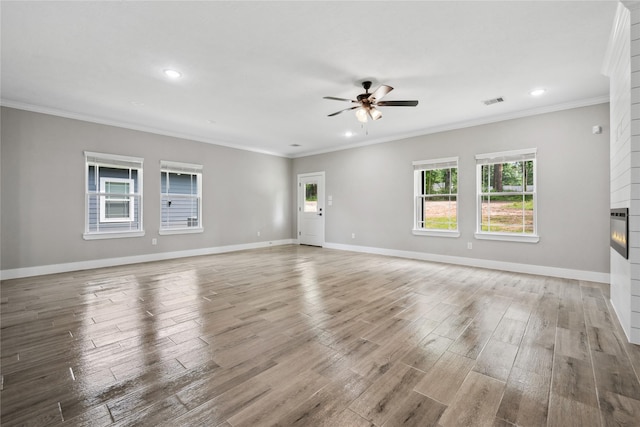 unfurnished living room with recessed lighting, ceiling fan, light wood-type flooring, crown molding, and baseboards