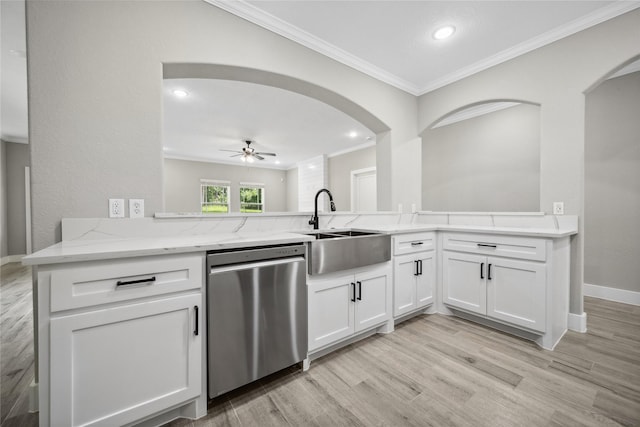 kitchen featuring a sink, light wood-style floors, light stone counters, ornamental molding, and dishwasher