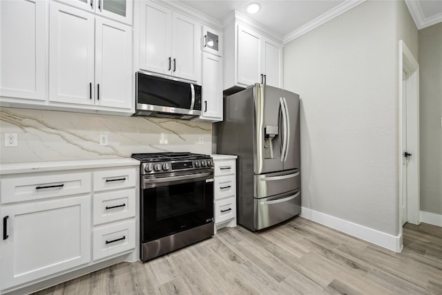 kitchen with appliances with stainless steel finishes, decorative backsplash, crown molding, and baseboards