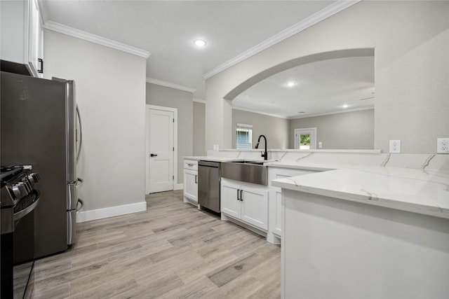 kitchen featuring stainless steel dishwasher, a sink, arched walkways, black range with gas stovetop, and light stone countertops
