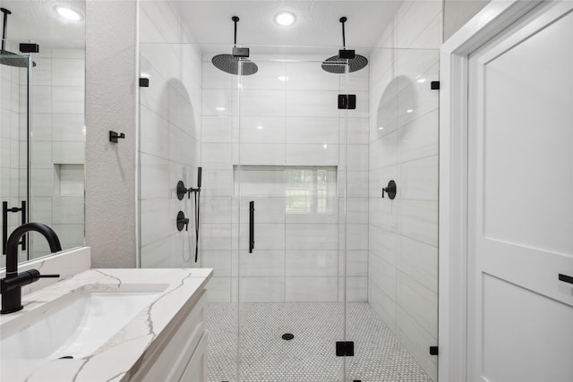bathroom featuring a stall shower, recessed lighting, and vanity