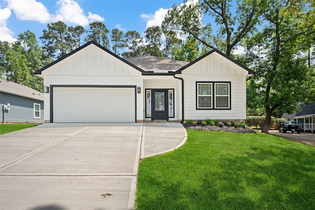 view of front of home with board and batten siding, a front lawn, driveway, and an attached garage