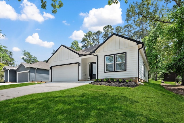 modern farmhouse style home with a front lawn, driveway, a garage, and board and batten siding