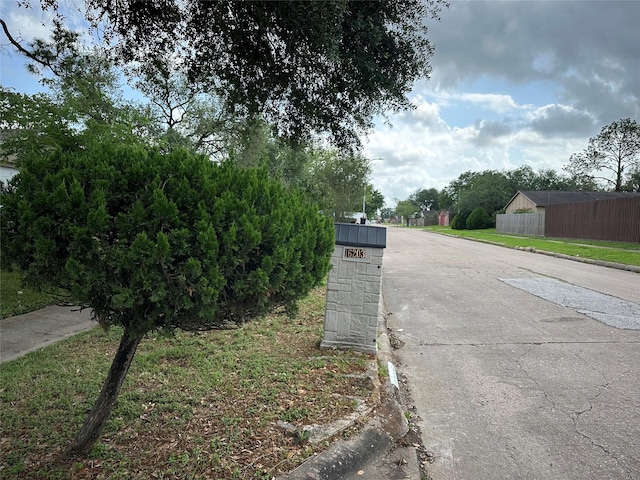view of street with curbs, sidewalks, and street lights