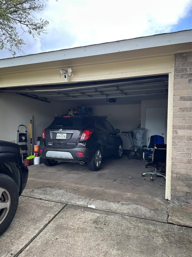 garage featuring a garage door opener and concrete driveway