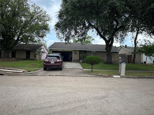 ranch-style home featuring a front yard, driveway, and a garage