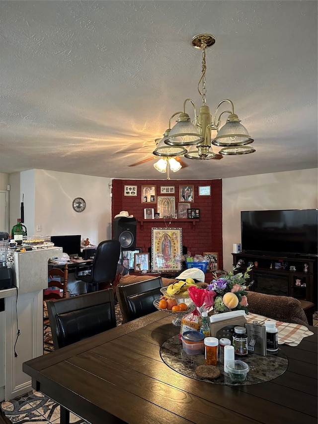 dining room with a textured ceiling and ceiling fan with notable chandelier