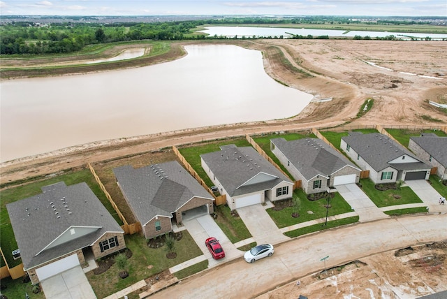 bird's eye view featuring a water view and a residential view