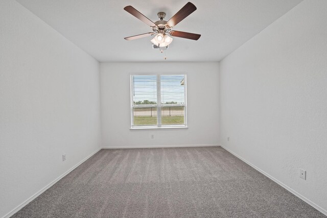 empty room with a ceiling fan, carpet, and baseboards