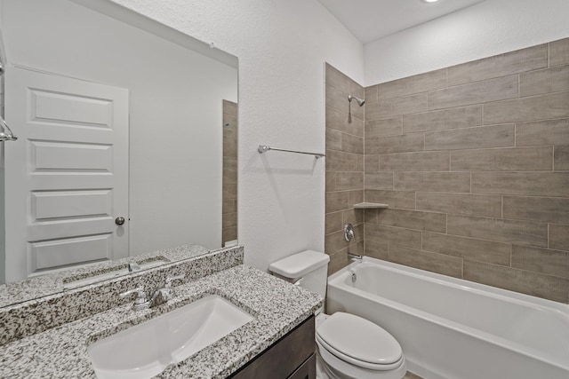 bathroom featuring toilet, washtub / shower combination, and vanity