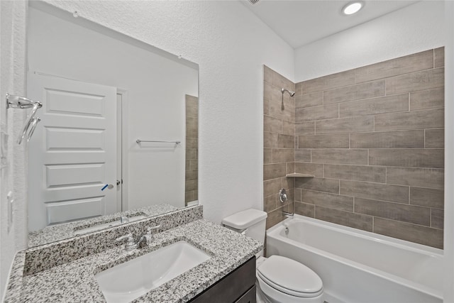 full bathroom featuring toilet, a textured wall, vanity, and shower / bathing tub combination