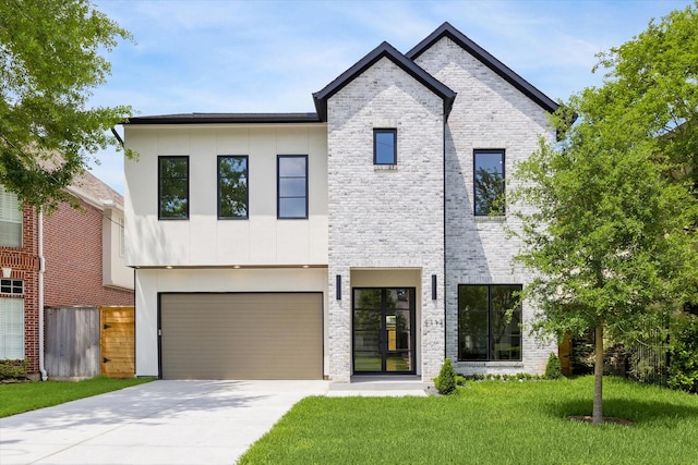 modern home featuring concrete driveway, a front yard, brick siding, and a garage