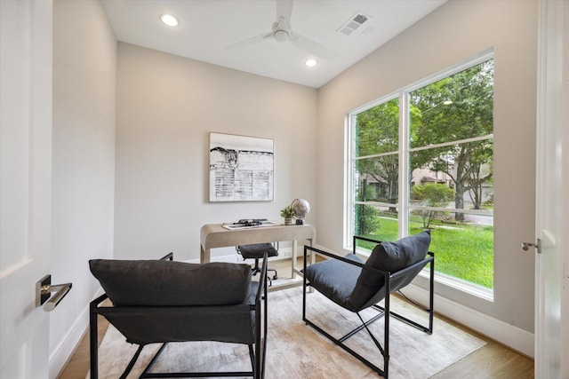 office area with visible vents, a healthy amount of sunlight, and baseboards