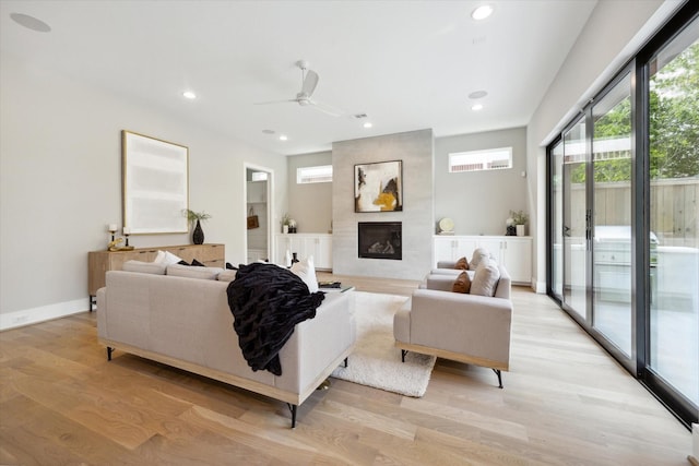 living room with a large fireplace, light wood-style floors, visible vents, recessed lighting, and a ceiling fan