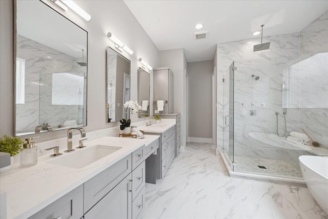 full bath featuring marble finish floor, a freestanding tub, vanity, visible vents, and a marble finish shower