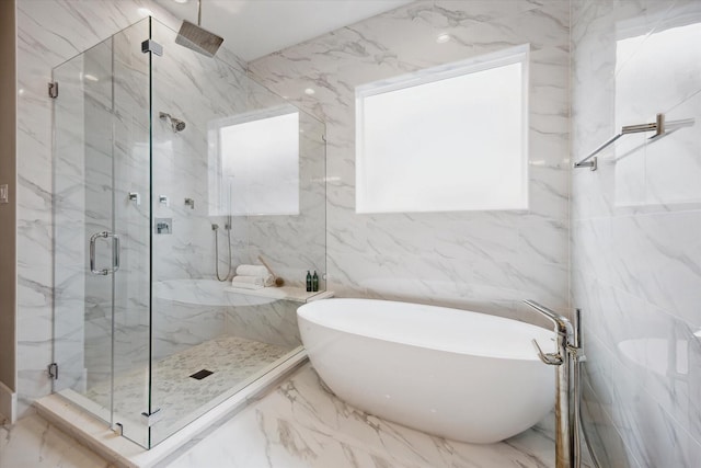 full bathroom featuring a marble finish shower, tile walls, a freestanding tub, and marble finish floor