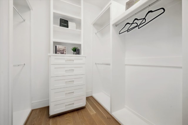 walk in closet featuring light wood-style flooring