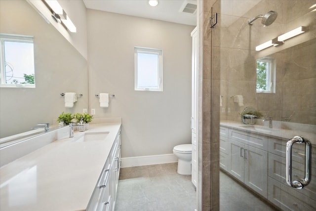 bathroom featuring visible vents, vanity, and a tile shower