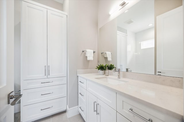 bathroom with baseboards, visible vents, tile patterned floors, and vanity