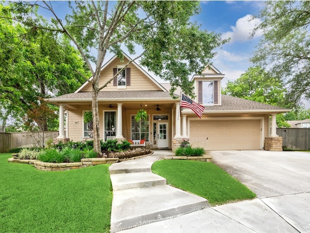 1603 Evening Bend Ct, Sugar Land, TX 77479 - view of front facade with driveway, ceiling fan, a porch, a garage, and roof with shingles