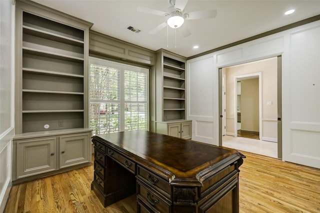 4856 Post Oak Timber Dr, Houston, TX 77056 - office featuring a decorative wall, light wood-style floors, built in shelves, visible vents, and a ceiling fan