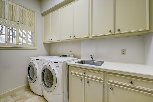 4856 Post Oak Timber Dr, Houston, TX 77056 - clothes washing area featuring a sink, cabinet space, washer and clothes dryer, light tile patterned flooring, and baseboards