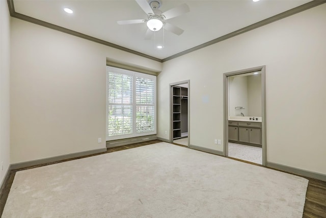 4856 Post Oak Timber Dr, Houston, TX 77056 - unfurnished bedroom featuring a closet, baseboards, ornamental molding, carpet, and ensuite bath