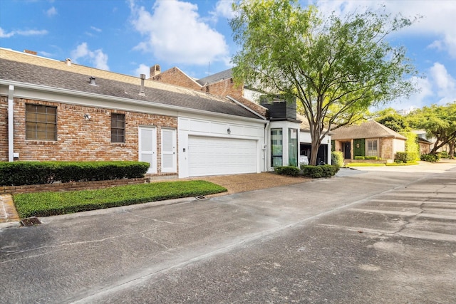 4856 Post Oak Timber Dr, Houston, TX 77056 - ranch-style house with concrete driveway, brick siding, and an attached garage