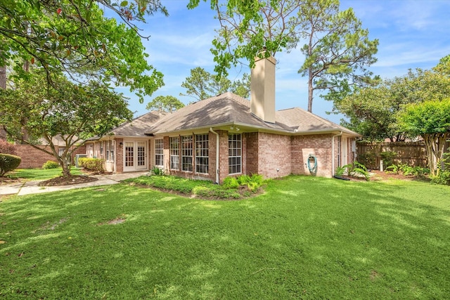 16610 Shadow Path Dr, Houston, TX 77059 - rear view of house with brick siding, a chimney, and french doors