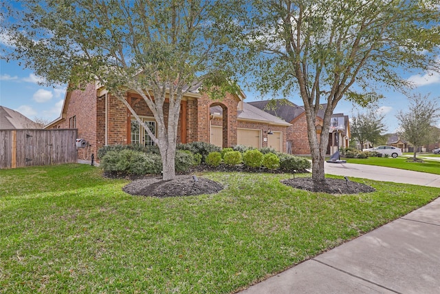 obstructed view of property featuring brick siding, a front yard, a garage, and fence