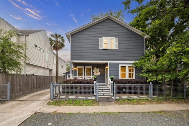 1111 Adele St, Houston, TX 77009 - traditional-style house featuring a gate, covered porch, and a fenced front yard