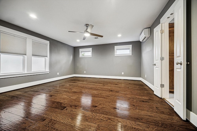 1111 Adele St, Houston, TX 77009 - unfurnished room with a ceiling fan, baseboards, an AC wall unit, recessed lighting, and hardwood / wood-style floors