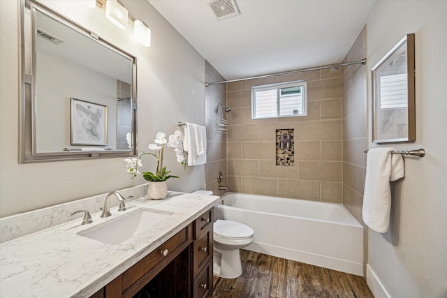 1111 Adele St, Houston, TX 77009 - full bathroom with tub / shower combination, toilet, wood finished floors, and visible vents