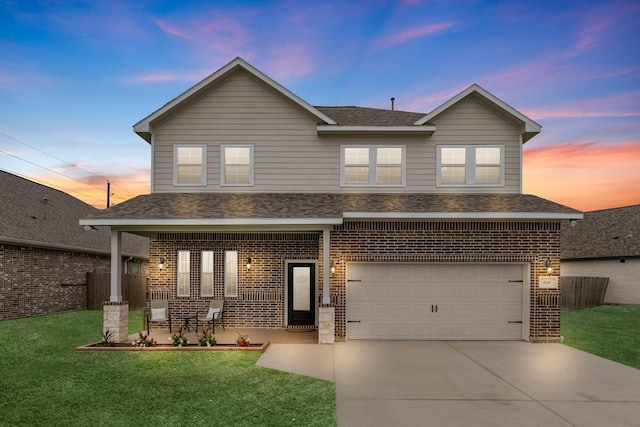 traditional-style home with brick siding, a shingled roof, driveway, and a front yard
