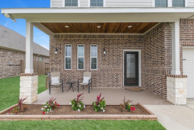 doorway to property with fence and brick siding