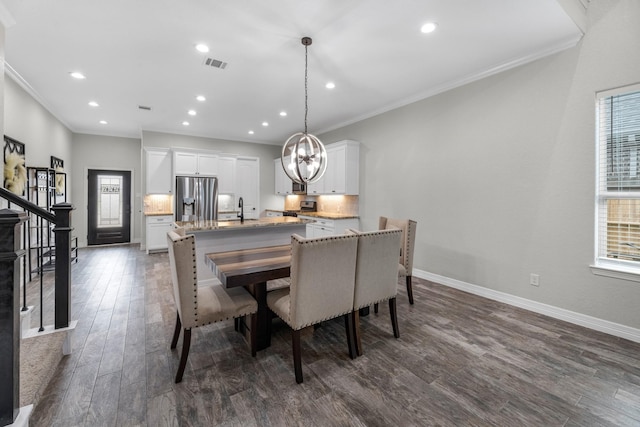 dining space with visible vents, baseboards, an inviting chandelier, ornamental molding, and dark wood finished floors