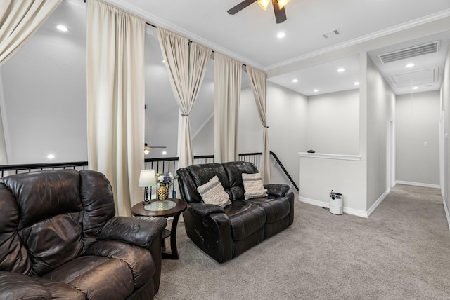 carpeted living room with baseboards, visible vents, attic access, and ceiling fan