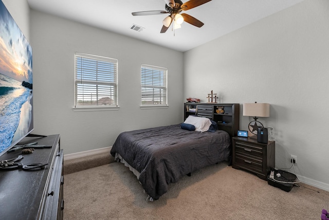 bedroom with baseboards, visible vents, ceiling fan, and carpet floors