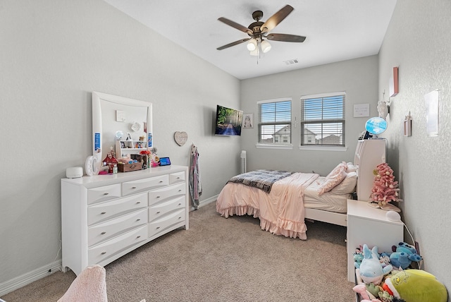 bedroom featuring light colored carpet, visible vents, a ceiling fan, and baseboards