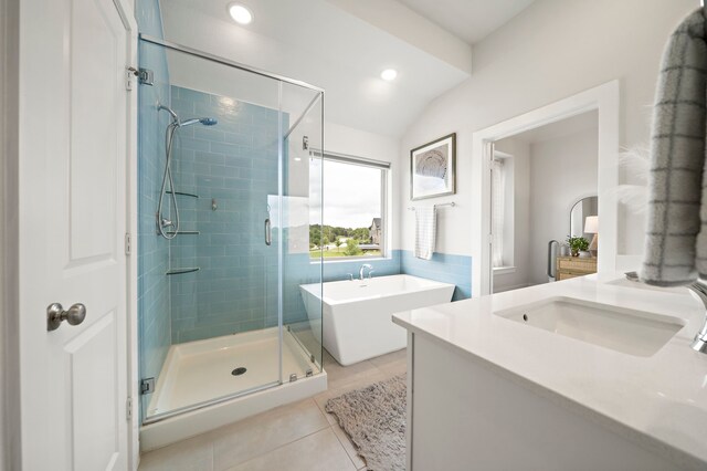 full bathroom with a freestanding bath, tile patterned flooring, vanity, a shower stall, and vaulted ceiling