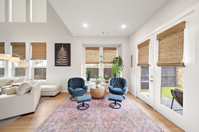 interior space with visible vents, plenty of natural light, french doors, and light wood-style floors