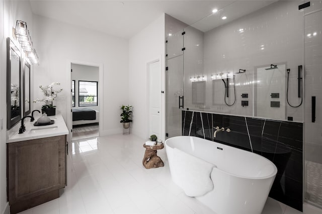 5008 Holt St, Bellaire, TX 77401 - ensuite bathroom with tile walls, a shower stall, connected bathroom, vanity, and a freestanding tub